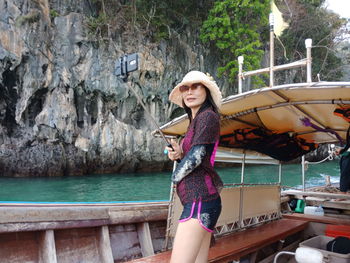 Woman taking selfie while standing on boat