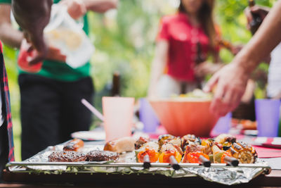 Close-up of people on barbecue grill