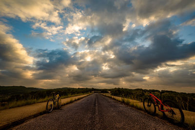 Empty road on field against sky