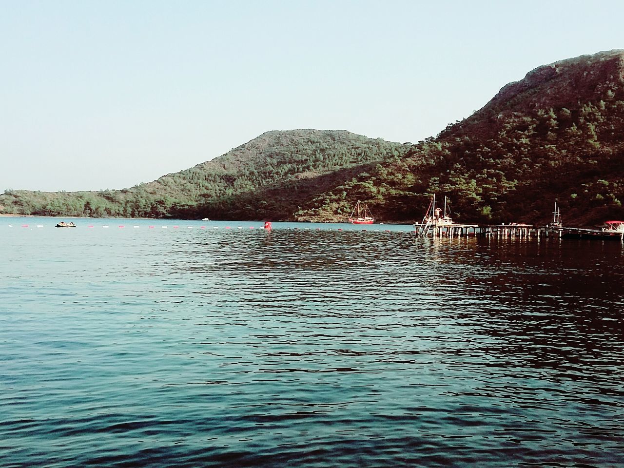 water, clear sky, waterfront, rippled, nature, day, sky, tranquility, beauty in nature, outdoors, tree, scenics, tranquil scene, no people, sea, mountain, architecture