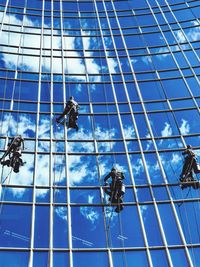 Low angle view of workers cleaning office building