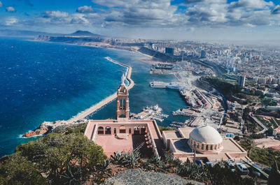 High angle view of buildings against cloudy sky