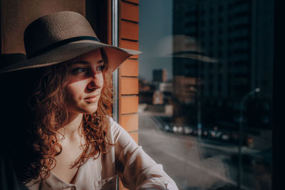 Portrait of young woman wearing hat
