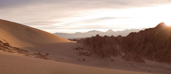 Scenic view of desert against sky during sunset