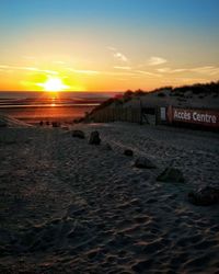 Scenic view of beach against sky during sunset