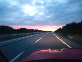 Road against sky seen through car windshield