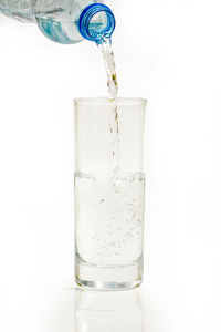 Close-up of glass bottle against white background