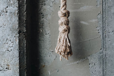 Close-up of rope hanging against wall