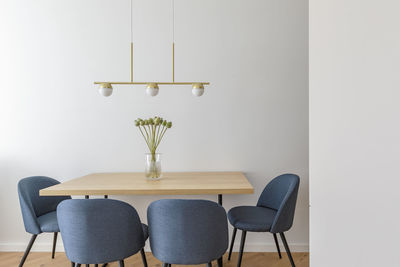 Potted plant on table against wall