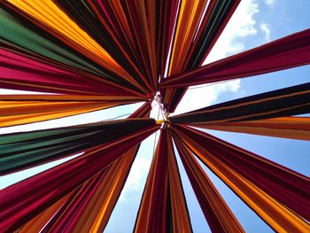Low angle view of multi colored fabric against sky