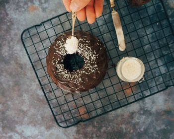 High angel view of hand decorating cake