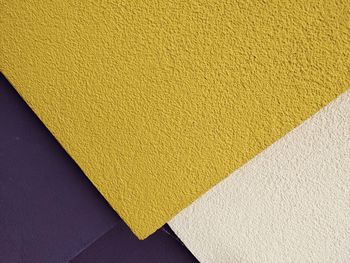 High angle view of yellow paper on wall