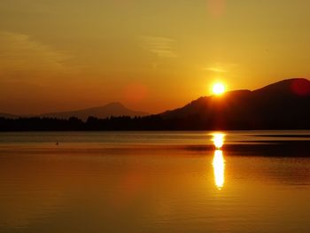 Scenic view of lake against romantic sky at sunset