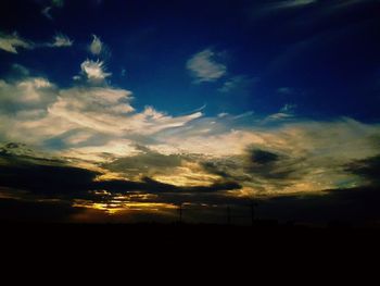 Low angle view of silhouette trees against sky at sunset