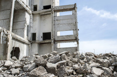 Low angle view of abandoned building against sky