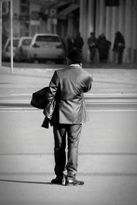 Rear view of businessman standing on city street