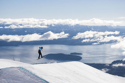 Rear view of person snowboarding