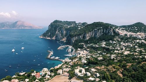 High angle view of sea and mountains against sky