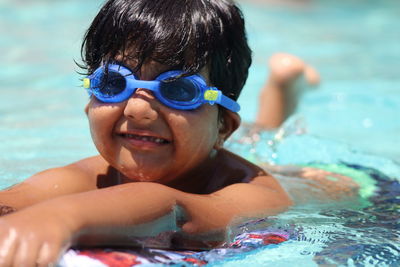 Portrait of boy swimming in pool