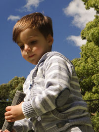 Low angle view of boy against clear sky