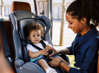 Mother with son sitting in car