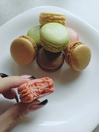 Close-up of hand holding food in plate