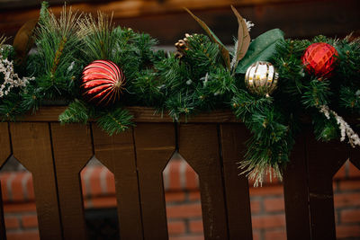 Close-up of christmas decorations on fence