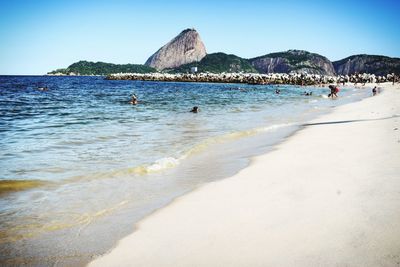 Scenic view of beach against clear sky