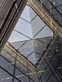 Low angle view of building seen through glass window