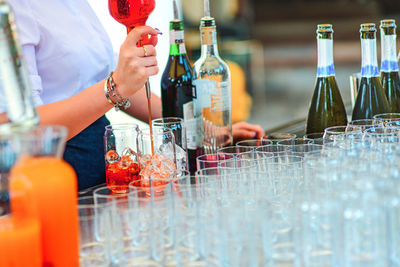 Midsection of woman holding champagne flute