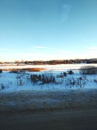 Scenic view of lake against sky during winter