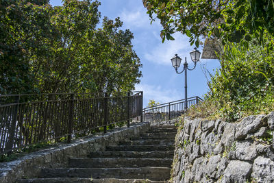 Street by wall against sky