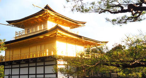 Low angle view of illuminated building against sky