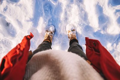 Low section of person standing on snow