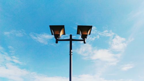 Low angle view of street light against blue sky