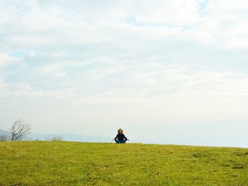 Scenic view of grassy field against sky