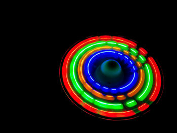Multi colored illuminated lights against black background
