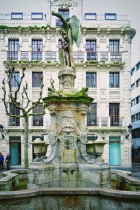 Statue of building with city in background