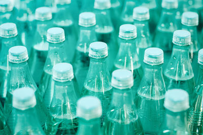 Mineral drinking water in green plastic bottles in the grocery store