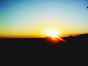 Scenic view of silhouette landscape against clear sky during sunset