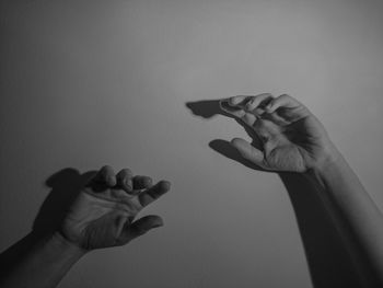 Cropped image of person hands against wall