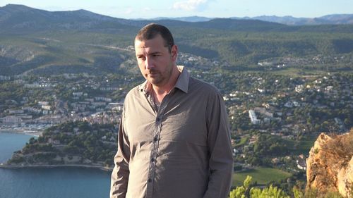 Portrait of young man standing on mountains