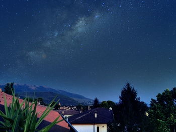 Scenic view of landscape against star field at night