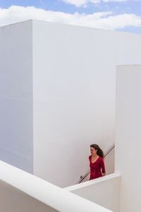 Portrait of woman against white wall