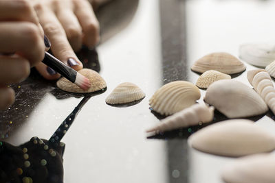 Woman painting seashells