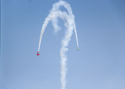 Low angle view of airplane flying against sky