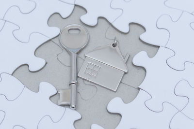 High angle view of house key on jigsaw puzzle