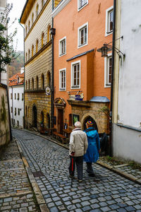 Rear view of senior couple walking on street