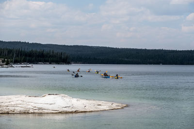 People in boat against sky