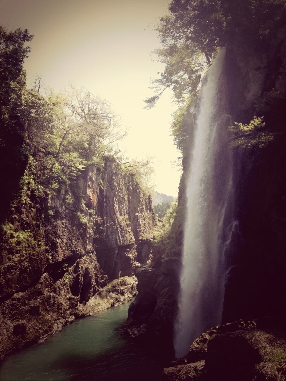 waterfall, water, motion, flowing water, scenics, beauty in nature, long exposure, tree, nature, flowing, rock - object, forest, blurred motion, tranquil scene, idyllic, rock formation, tranquility, clear sky, non-urban scene, day